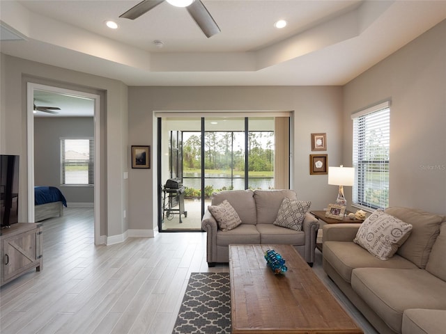 249 Tracino Ter, Nokomis, FL 34275 - living room with a ceiling fan, a tray ceiling, baseboards, light wood-style floors, and recessed lighting