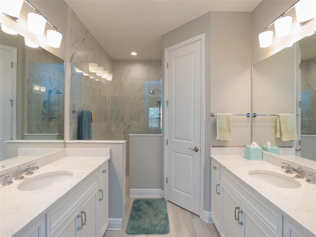 249 Tracino Ter, Nokomis, FL 34275 - full bathroom featuring tiled shower, two vanities, recessed lighting, and baseboards