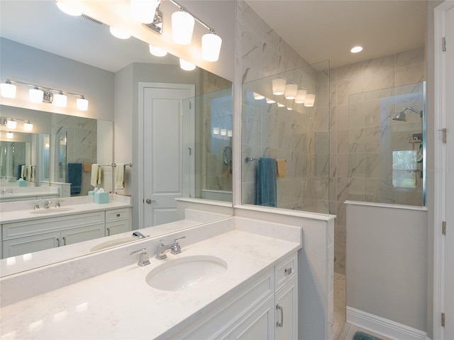 249 Tracino Ter, Nokomis, FL 34275 - bathroom featuring walk in shower and two vanities