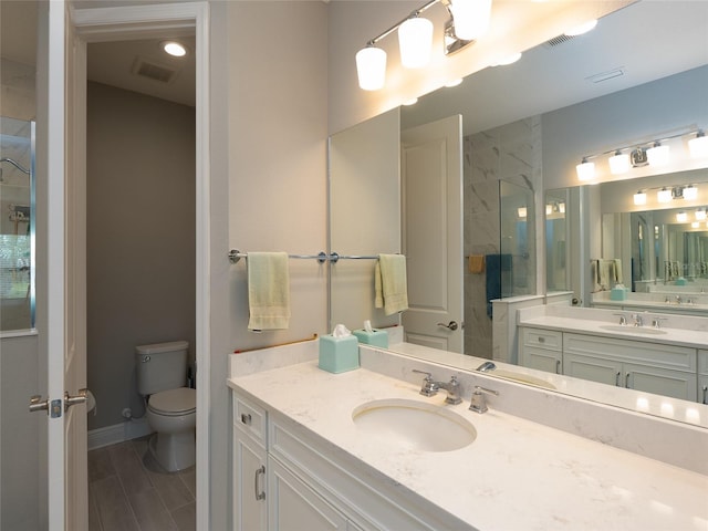 249 Tracino Ter, Nokomis, FL 34275 - bathroom featuring toilet, a tile shower, vanity, and baseboards