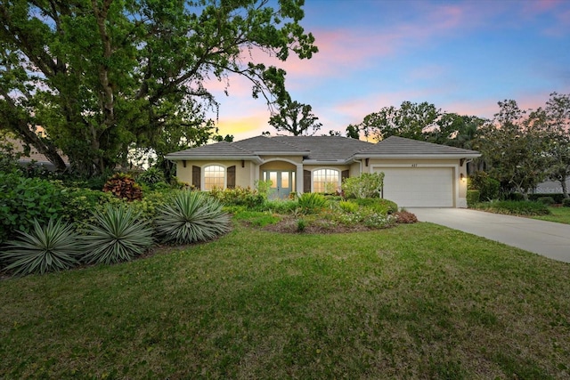 427 Autumn Chase Dr, Venice, FL 34292 - single story home with concrete driveway, a garage, a front lawn, and stucco siding