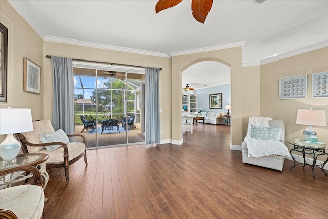 427 Autumn Chase Dr, Venice, FL 34292 - living area with a ceiling fan, a sunroom, wood finished floors, crown molding, and arched walkways