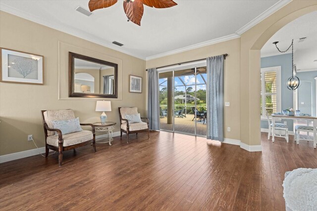 427 Autumn Chase Dr, Venice, FL 34292 - living area with ornamental molding, arched walkways, wood finished floors, baseboards, and a ceiling fan