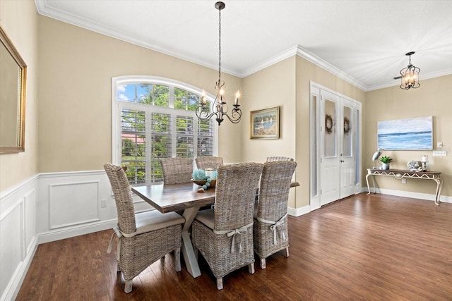 427 Autumn Chase Dr, Venice, FL 34292 - dining room with a chandelier, dark wood-style floors, crown molding, and a wainscoted wall