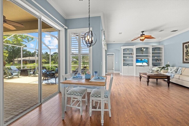 427 Autumn Chase Dr, Venice, FL 34292 - dining room featuring a ceiling fan, crown molding, wood finished floors, and a chandelier