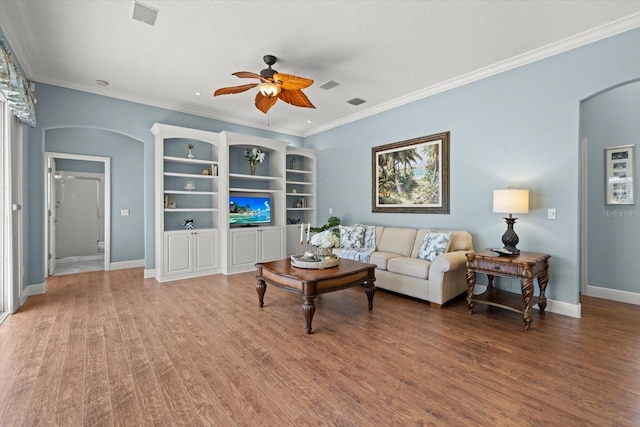 427 Autumn Chase Dr, Venice, FL 34292 - living area featuring arched walkways, ceiling fan, wood finished floors, ornamental molding, and baseboards