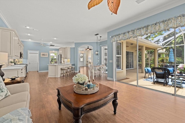 427 Autumn Chase Dr, Venice, FL 34292 - living room with ceiling fan, ornamental molding, light wood-style flooring, baseboards, and recessed lighting