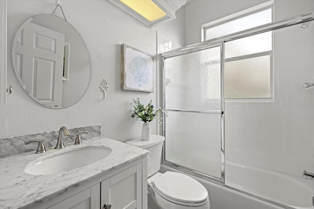 427 Autumn Chase Dr, Venice, FL 34292 - bathroom featuring bath / shower combo with glass door, vanity, and toilet