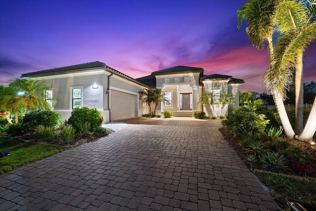 329 Myrtle Ave, Nokomis, FL 34275 - mediterranean / spanish house with decorative driveway, a garage, stucco siding, and a tile roof