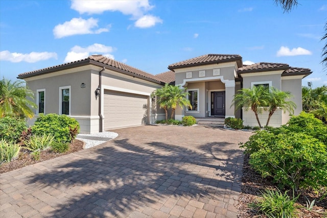 329 Myrtle Ave, Nokomis, FL 34275 - mediterranean / spanish-style house featuring stucco siding, decorative driveway, an attached garage, and a tiled roof