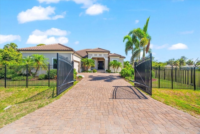 329 Myrtle Ave, Nokomis, FL 34275 - mediterranean / spanish home with decorative driveway, a garage, a gate, and stucco siding