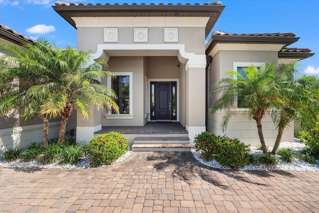 329 Myrtle Ave, Nokomis, FL 34275 - view of exterior entry featuring stucco siding and a tile roof