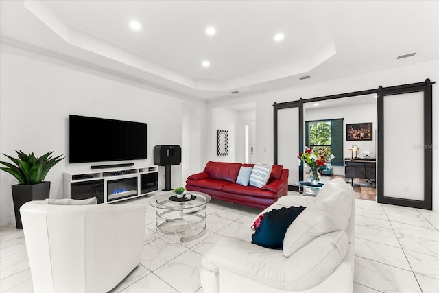 329 Myrtle Ave, Nokomis, FL 34275 - living room featuring light marble finish flooring, a raised ceiling, a barn door, and recessed lighting