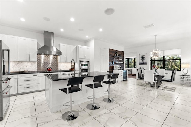 329 Myrtle Ave, Nokomis, FL 34275 - kitchen with wall chimney exhaust hood, dark countertops, light marble finish floors, stainless steel appliances, and tasteful backsplash