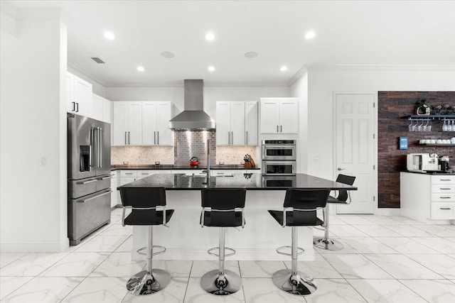 329 Myrtle Ave, Nokomis, FL 34275 - kitchen with appliances with stainless steel finishes, wall chimney range hood, ornamental molding, dark countertops, and a kitchen bar