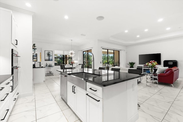 329 Myrtle Ave, Nokomis, FL 34275 - kitchen featuring a sink, recessed lighting, dark countertops, light marble finish flooring, and a kitchen island with sink