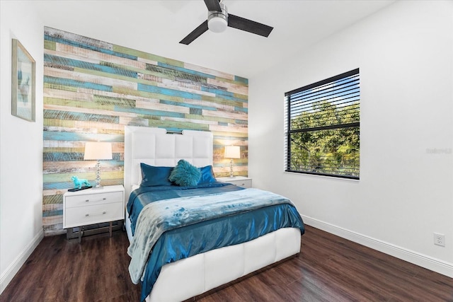 329 Myrtle Ave, Nokomis, FL 34275 - bedroom featuring baseboards, wood finished floors, an accent wall, and a ceiling fan