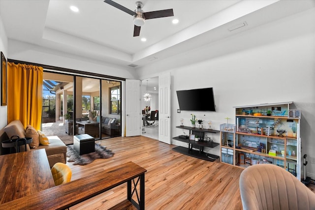 329 Myrtle Ave, Nokomis, FL 34275 - living room featuring a ceiling fan, wood finished floors, recessed lighting, and a tray ceiling