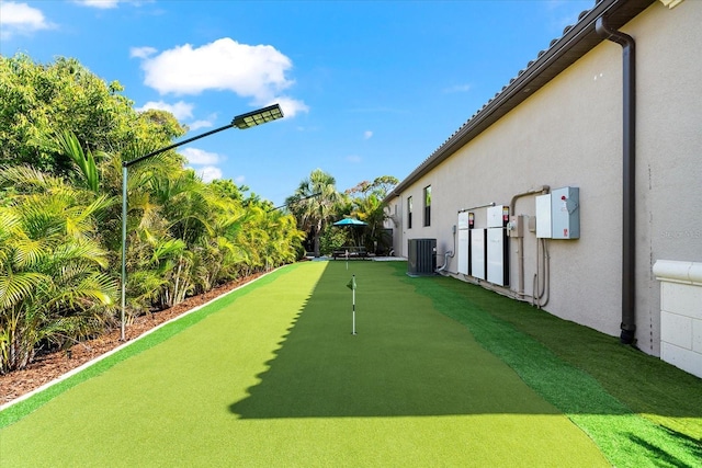329 Myrtle Ave, Nokomis, FL 34275 - view of yard featuring a putting green and central AC unit