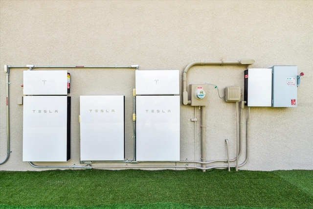 329 Myrtle Ave, Nokomis, FL 34275 - exterior view of wall-mounted power storage and stucco siding