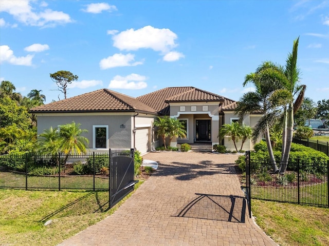 329 Myrtle Ave, Nokomis, FL 34275 - mediterranean / spanish-style home with a garage, decorative driveway, a tiled roof, and stucco siding