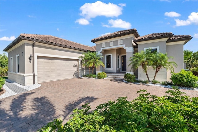 329 Myrtle Ave, Nokomis, FL 34275 - mediterranean / spanish home with a garage, stucco siding, decorative driveway, and a tile roof