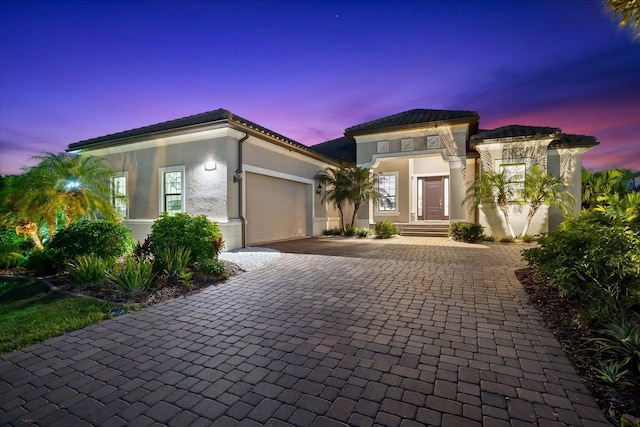 329 Myrtle Ave, Nokomis, FL 34275 - view of front of property featuring decorative driveway, an attached garage, stucco siding, and a tiled roof