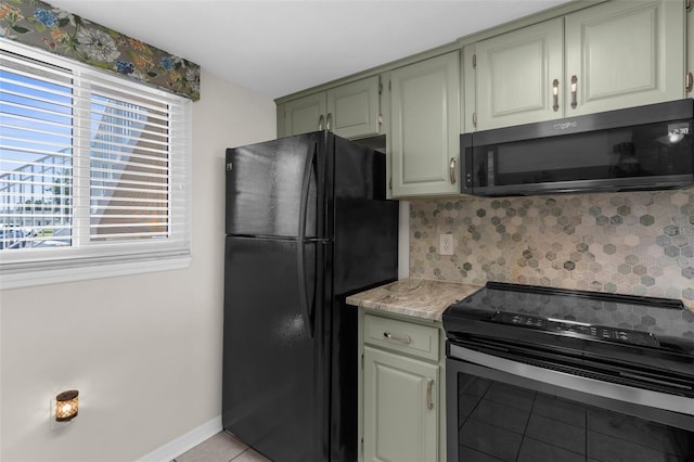 kitchen featuring black appliances, light tile patterned flooring, baseboards, and decorative backsplash
