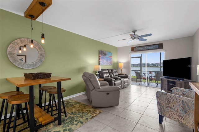 living area with ceiling fan, tile patterned floors, and baseboards