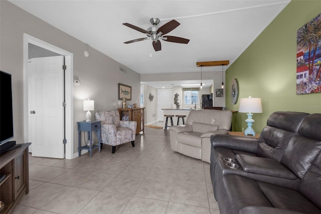living room with a ceiling fan and light tile patterned flooring