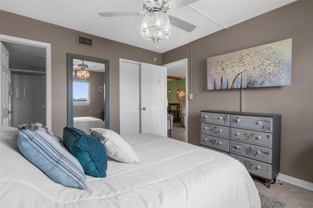 bedroom featuring two closets, light tile patterned flooring, baseboards, and a ceiling fan