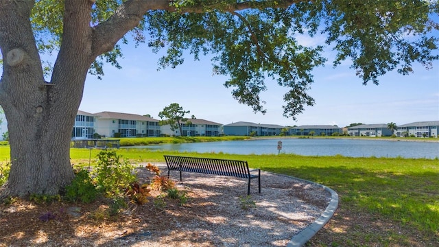 surrounding community featuring a residential view, a water view, and a lawn