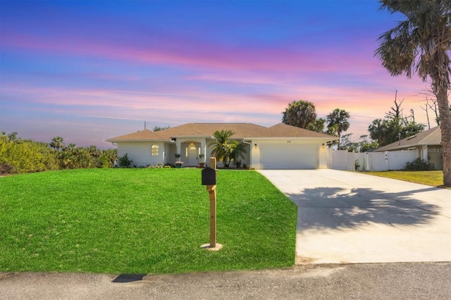 ranch-style house featuring a garage, concrete driveway, and stucco siding