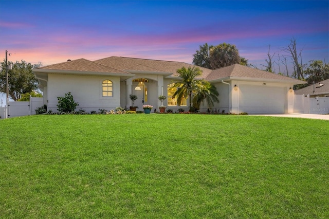 ranch-style house with a garage, stucco siding, concrete driveway, a gate, and a shingled roof