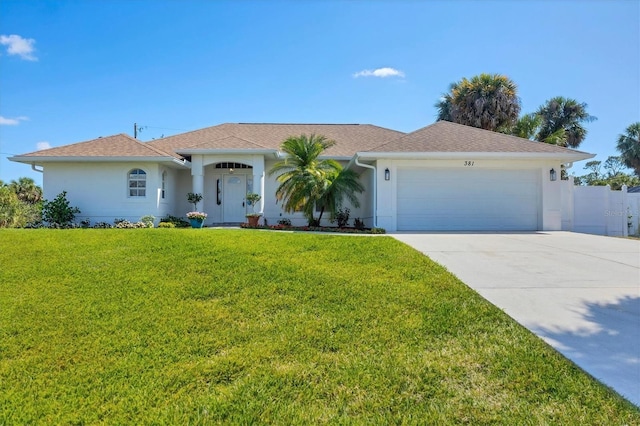 view of front of property featuring driveway, an attached garage, stucco siding, and a front yard