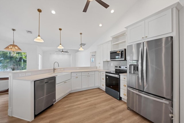 kitchen with appliances with stainless steel finishes, ceiling fan, a peninsula, open shelves, and a sink
