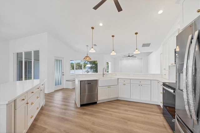 kitchen featuring appliances with stainless steel finishes, a ceiling fan, a sink, light countertops, and white cabinets