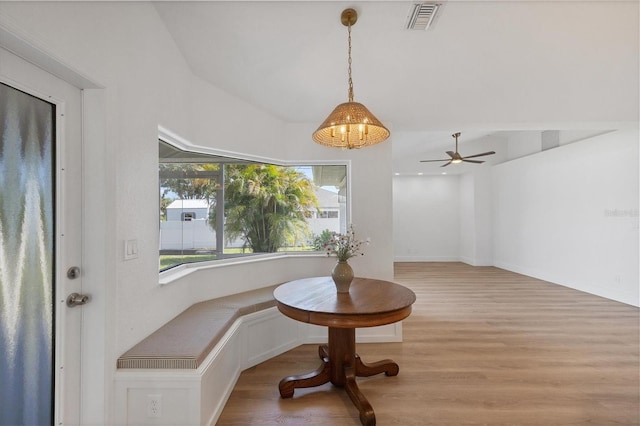 dining area with wood finished floors and ceiling fan