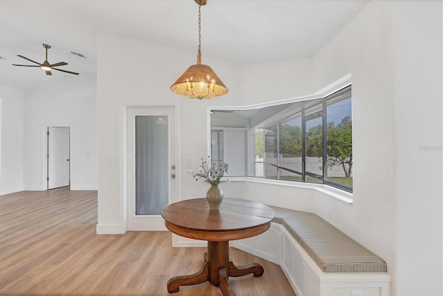 dining room with light wood-type flooring, a ceiling fan, and breakfast area