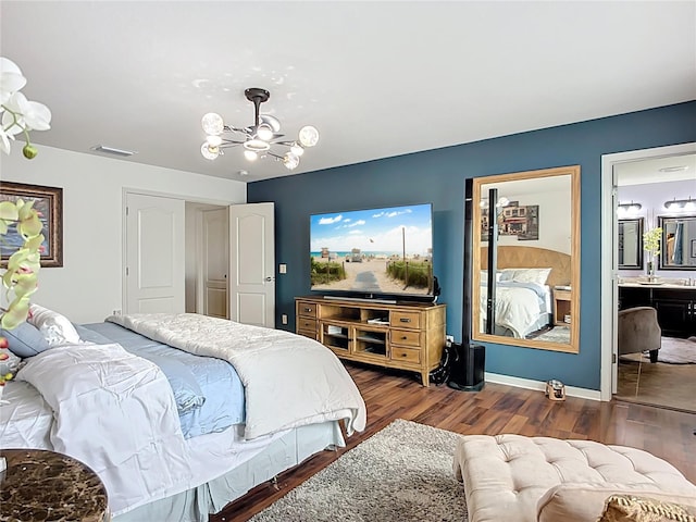 9019 39th Street Cir E, Parrish, FL 34219 - bedroom featuring a chandelier, wood finished floors, ensuite bath, and baseboards