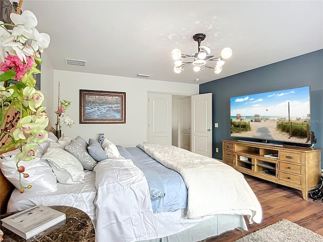 9019 39th Street Cir E, Parrish, FL 34219 - bedroom featuring a chandelier and wood finished floors