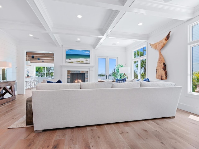 3516 Casey Key Rd, Nokomis, FL 34275 - living room with coffered ceiling, plenty of natural light, a warm lit fireplace, beam ceiling, and light wood-style flooring