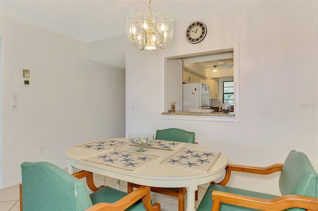 1730 Manasota Beach Rd Unit 215, Englewood, FL 34223 - dining room with a chandelier, light tile patterned flooring, baseboards, and ceiling fan