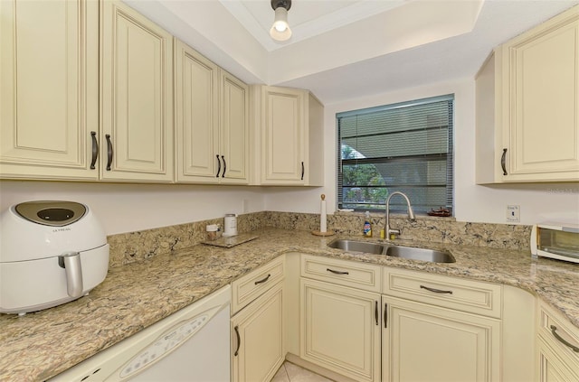1730 Manasota Beach Rd Unit 215, Englewood, FL 34223 - kitchen with a sink, cream cabinets, white dishwasher, a tray ceiling, and light stone countertops