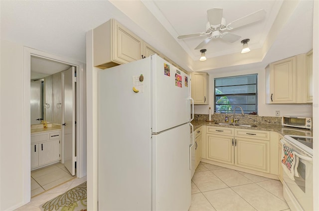 1730 Manasota Beach Rd Unit 215, Englewood, FL 34223 - kitchen with white appliances, cream cabinets, a sink, light tile patterned floors, and a ceiling fan