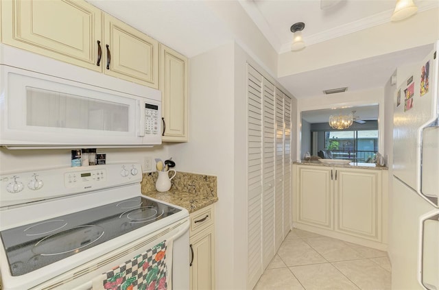 1730 Manasota Beach Rd Unit 215, Englewood, FL 34223 - kitchen with white appliances, cream cabinetry, crown molding, a chandelier, and light tile patterned flooring