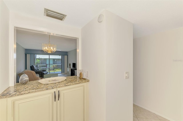 1730 Manasota Beach Rd Unit 215, Englewood, FL 34223 - bar area with light tile patterned floors and a chandelier