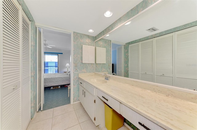 1730 Manasota Beach Rd Unit 215, Englewood, FL 34223 - full bathroom featuring a closet, connected bathroom, vanity, tile patterned flooring, and wallpapered walls