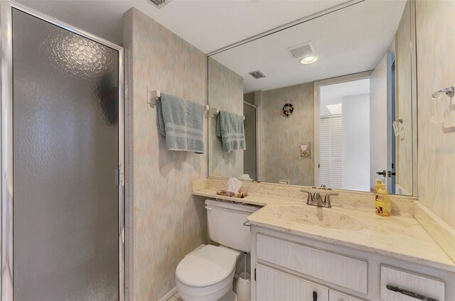1730 Manasota Beach Rd Unit 215, Englewood, FL 34223 - bathroom featuring vanity, a shower stall, toilet, and wallpapered walls