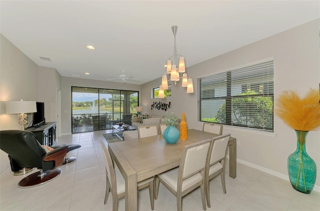 20636 Swallowtail Ct, Venice, FL 34293 - dining room with baseboards, light tile patterned floors, ceiling fan, recessed lighting, and a chandelier